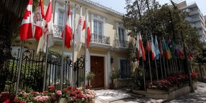 Flags outside an embassy building in Lima’s diplomatic district