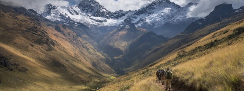 Travelers experiencing Peru's diverse seasons from the dry winter months with clear mountain views and perfect trekking conditions to the lush green rainy season with fewer crowds, dramatic cloud formations, and vibrant landscapes across different regions
