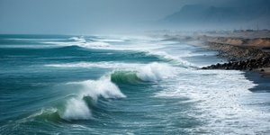 Waves rolling into the shore at Chicama, Peru