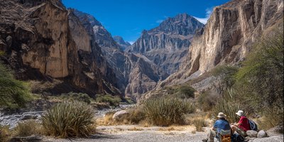 Hikers resting at an oasis inside the Colca Canyon with tall cliffs above