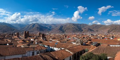 A panorama of Cusco’s red roofs with the Andes mountains in the background
