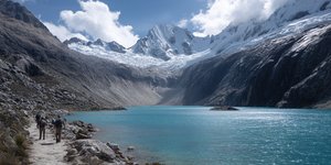 Hikers exploring Laguna 69 Hike with dramatic mountain scenery