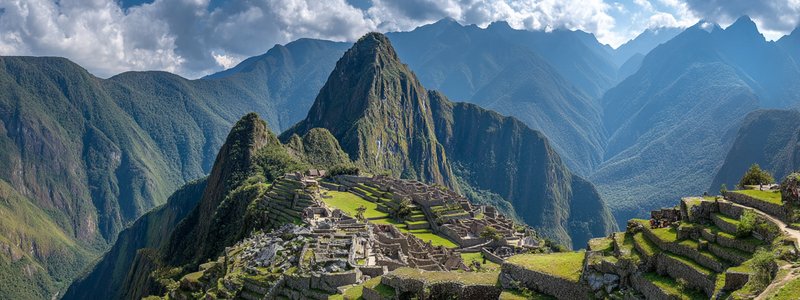 Panoramic view of Machu Picchu from above with Huayna Picchu and Machu Picchu Mountain in the background
