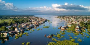 Aerial view of Iquitos city alongside the Amazon River with jungle in the distance