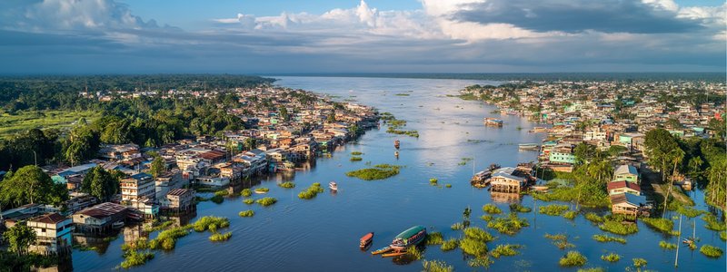 Aerial view of Iquitos city alongside the Amazon River with jungle in the distance
