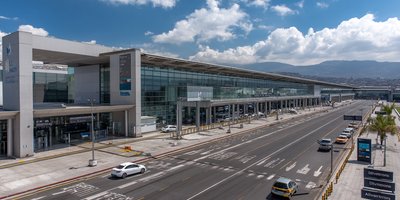 Wide view of Jorge Chávez International Airport (LIM) terminal with signage for Arrivals and Departures