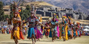 Traditional Inti Raymi sun festival in Cusco with colorful Inca ceremonial costumes, Quechua dancers performing ancient rituals with Sacsayhuamán fortress in background