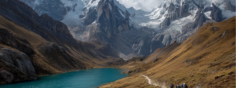 Trekkers following a glacial path through the Cordillera Huayhuash with towering peaks and turquoise lakes