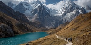 Trekkers following a glacial path through the Cordillera Huayhuash with towering peaks and turquoise lakes