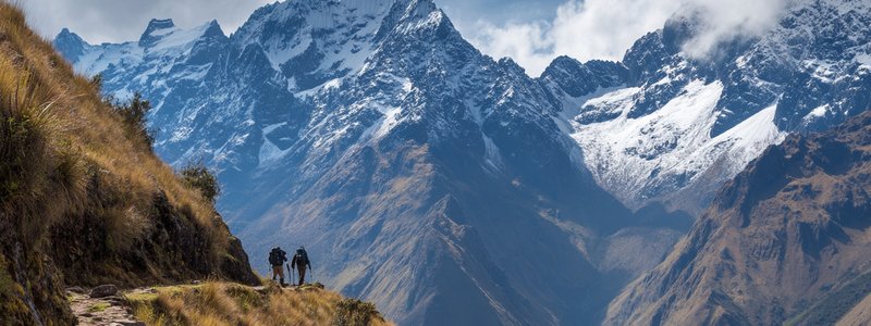 Hikers Pass on the Inca Trail with mountain scenery toward machupiccu