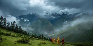 Group of hikers with rain gear and ponchos walking through Sacred Valley during rainy season with dramatic storm clouds over green Andean mountains